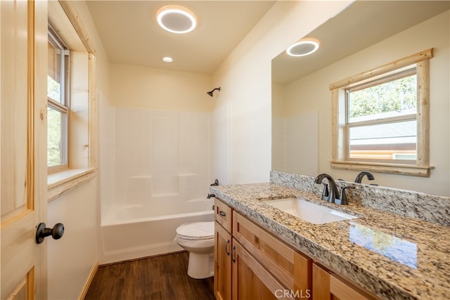 full bathroom with vanity, toilet, hardwood / wood-style flooring, and shower / bathtub combination