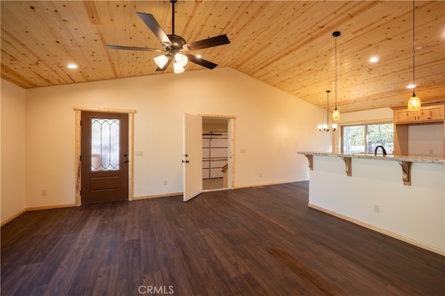 unfurnished living room featuring vaulted ceiling, wood ceiling, dark hardwood / wood-style floors, and ceiling fan with notable chandelier