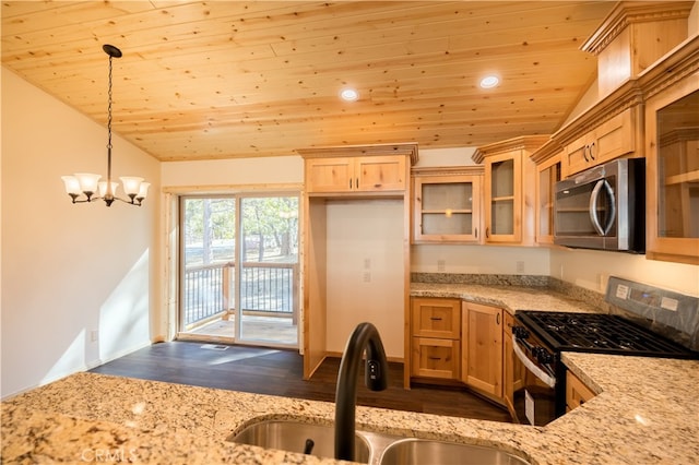 kitchen with gas stove, lofted ceiling, decorative light fixtures, and dark wood-type flooring