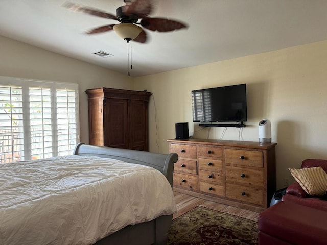 bedroom featuring hardwood / wood-style floors, ceiling fan, and lofted ceiling