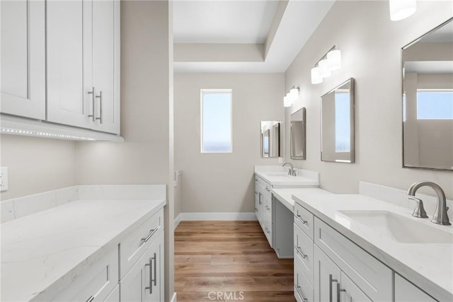 26176 Boulder View Ct, Menifee, CA 92584 - bathroom featuring plenty of natural light, two vanities, and wood finished floors
