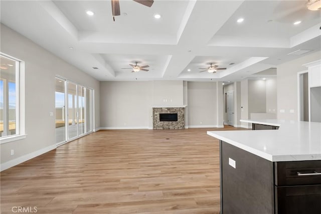 26176 Boulder View Ct, Menifee, CA 92584 - unfurnished living room with ceiling fan, light wood-style floors, a fireplace, coffered ceiling, and recessed lighting