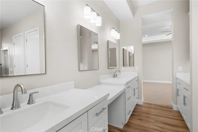 26176 Boulder View Ct, Menifee, CA 92584 - bathroom featuring two vanities and wood finished floors