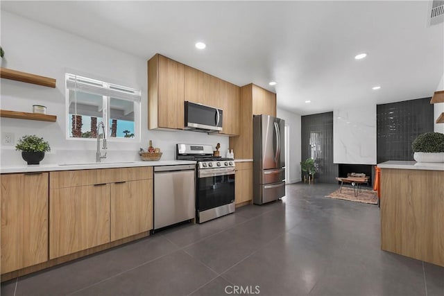 kitchen featuring sink, dark tile patterned flooring, and appliances with stainless steel finishes