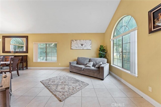 tiled living room featuring lofted ceiling