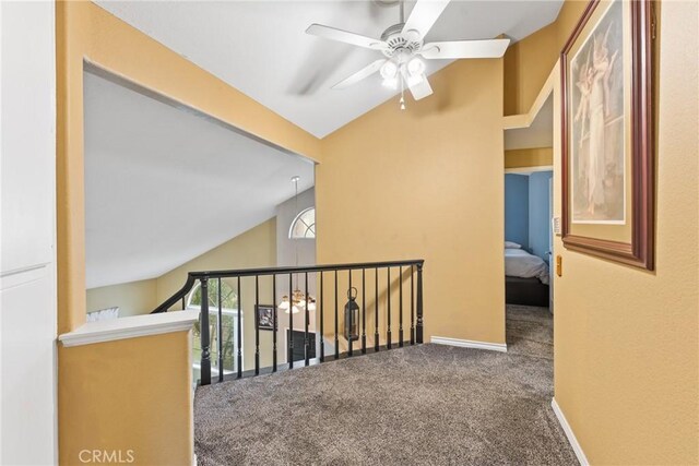 hallway featuring carpet and vaulted ceiling