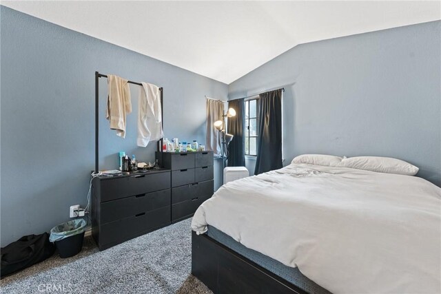 bedroom featuring carpet and lofted ceiling