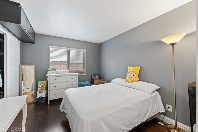 bedroom featuring dark hardwood / wood-style flooring