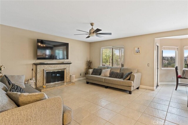 living room with ceiling fan and light tile patterned floors