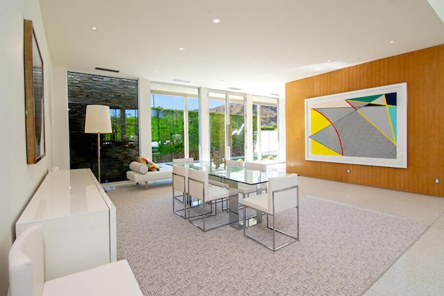 dining room featuring wood walls