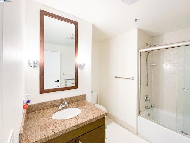 full bathroom featuring toilet, bath / shower combo with glass door, and vanity