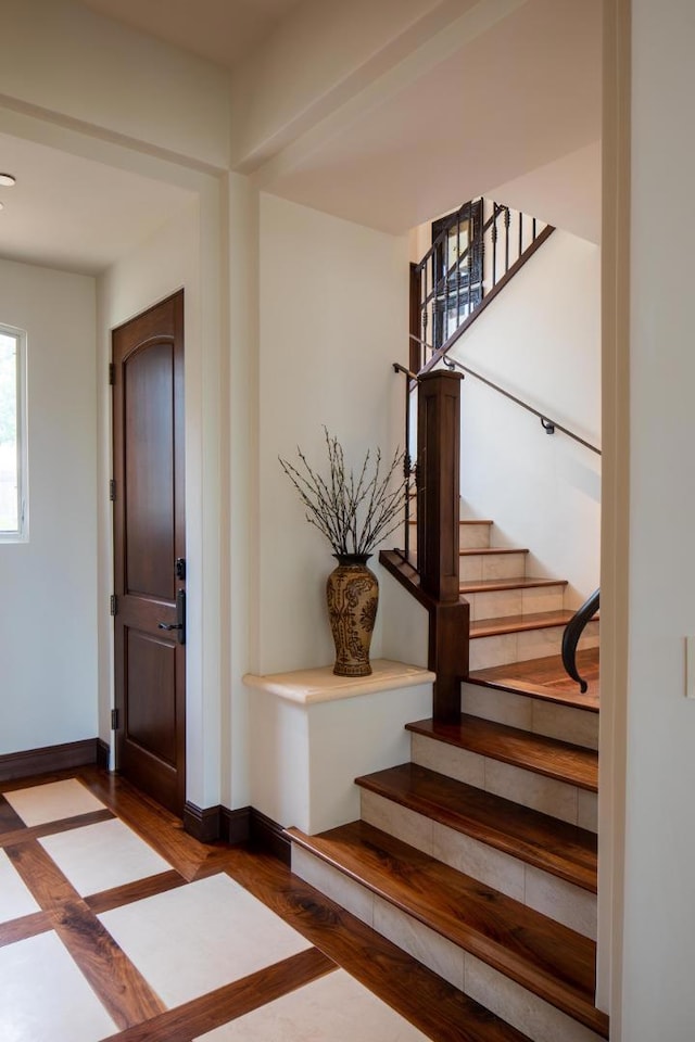 stairway featuring wood-type flooring