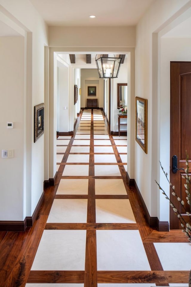 hallway featuring a chandelier