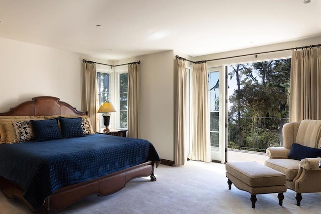 bedroom with light colored carpet and access to outside