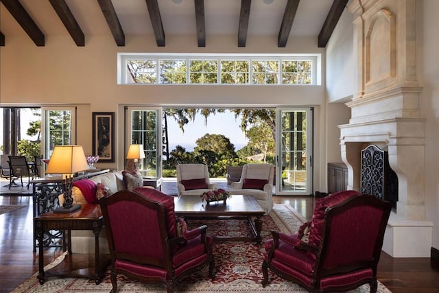 living room featuring dark hardwood / wood-style floors, a towering ceiling, and plenty of natural light