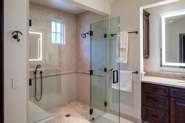 bathroom with vanity and a shower with door