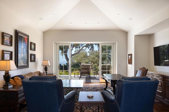 living room featuring dark hardwood / wood-style flooring and lofted ceiling