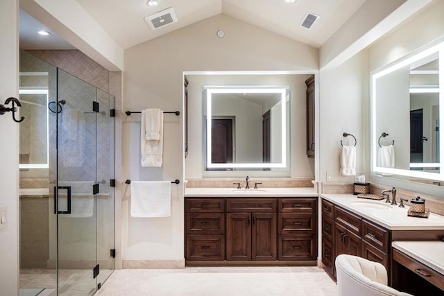 bathroom with vaulted ceiling, an enclosed shower, and vanity