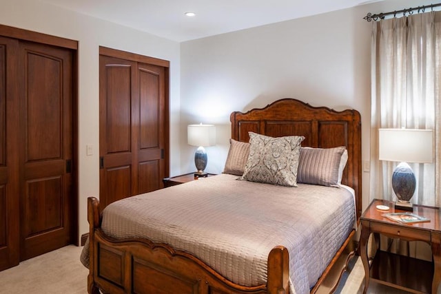 bedroom featuring light colored carpet