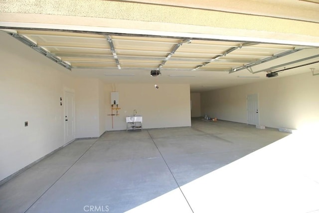 garage with water heater and a garage door opener