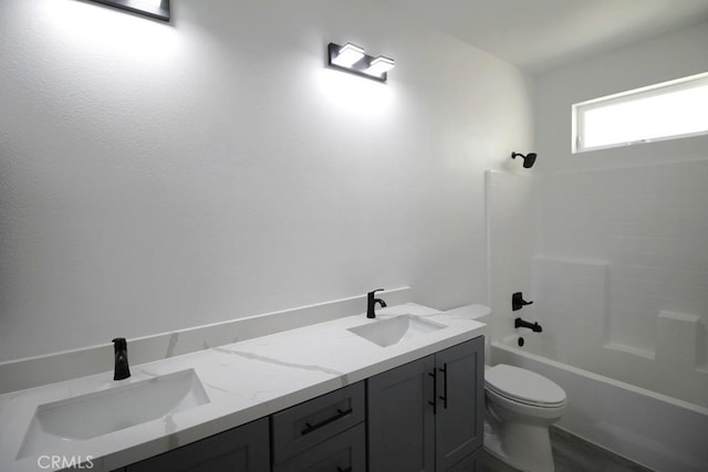 full bathroom featuring vanity, toilet, and washtub / shower combination