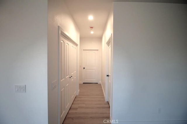 corridor with light wood-type flooring