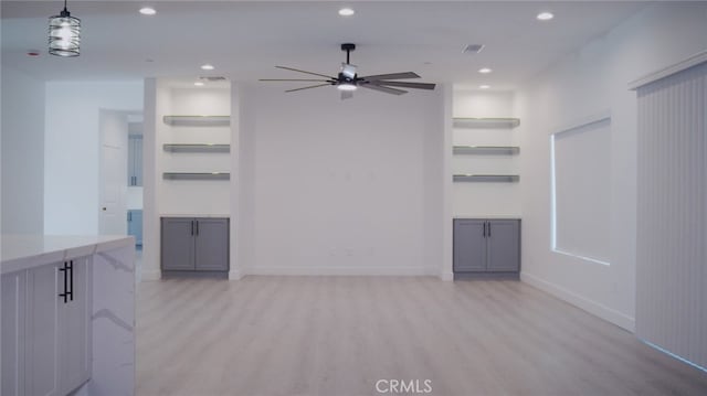 unfurnished living room featuring light hardwood / wood-style flooring and ceiling fan