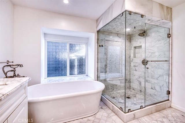 bathroom featuring vanity and independent shower and bath