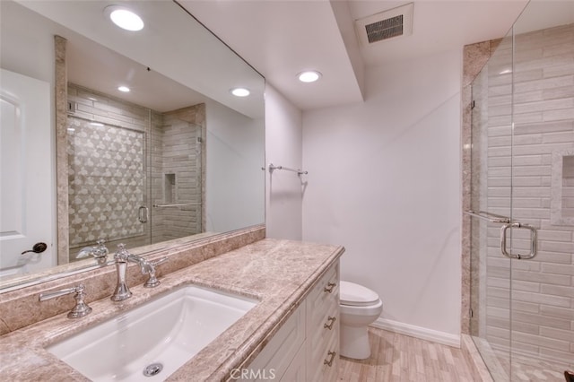 bathroom with vanity, an enclosed shower, toilet, and wood-type flooring