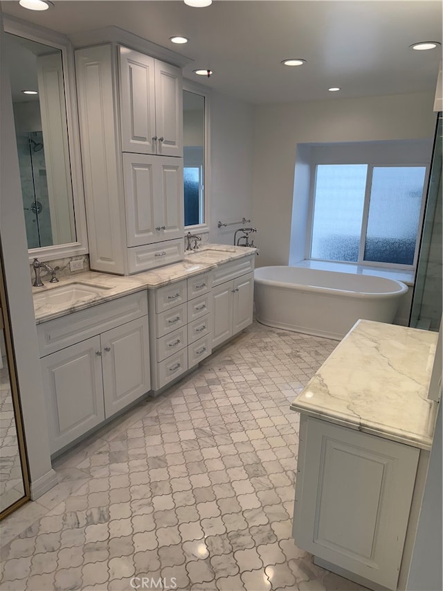 bathroom with vanity and a tub to relax in