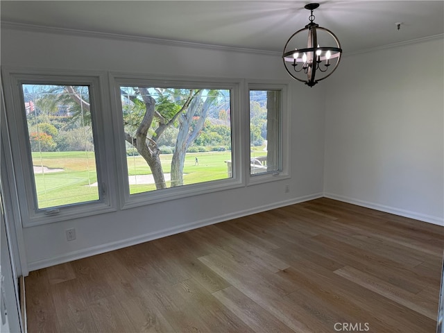 unfurnished dining area featuring a notable chandelier, hardwood / wood-style flooring, and a wealth of natural light