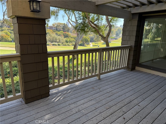 wooden deck featuring a lawn