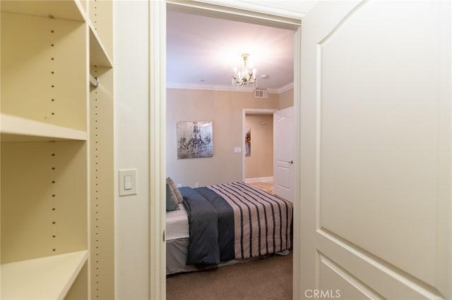 bedroom featuring crown molding, carpet floors, and a chandelier