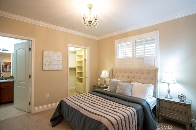 carpeted bedroom featuring a spacious closet, a closet, connected bathroom, a notable chandelier, and ornamental molding