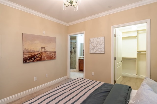 carpeted bedroom featuring a notable chandelier, a spacious closet, crown molding, a closet, and ensuite bath