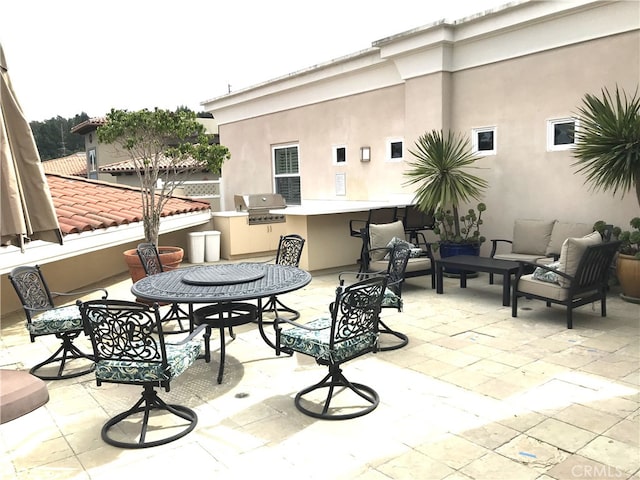 view of patio featuring an outdoor kitchen, outdoor lounge area, and a grill