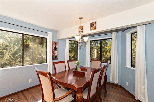 dining room with a chandelier and dark hardwood / wood-style floors