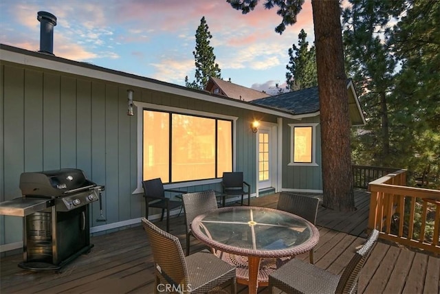 deck at dusk with grilling area