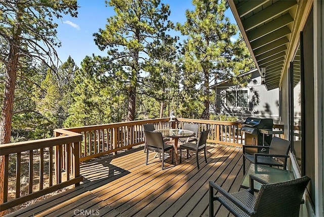 wooden deck featuring a grill