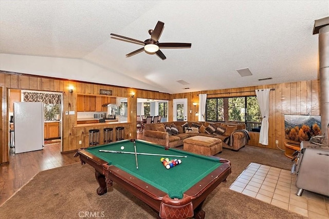 recreation room featuring ceiling fan, wooden walls, hardwood / wood-style flooring, billiards, and lofted ceiling