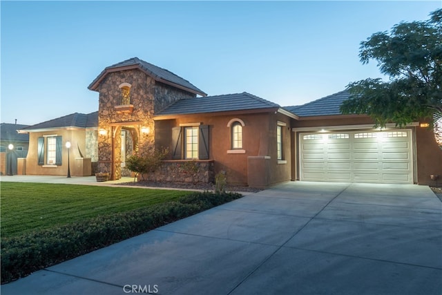 view of front of home featuring a lawn and a garage