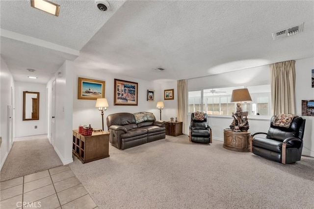 living room featuring light carpet and a textured ceiling