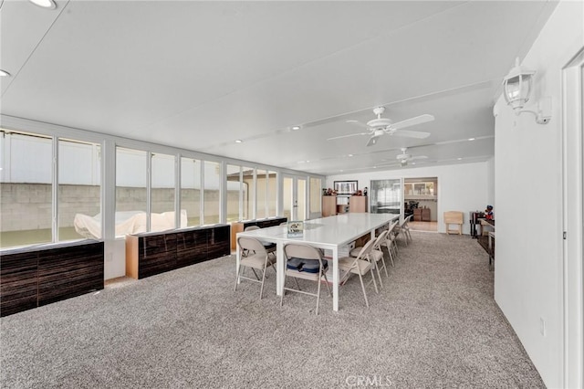 dining room with light carpet and ceiling fan