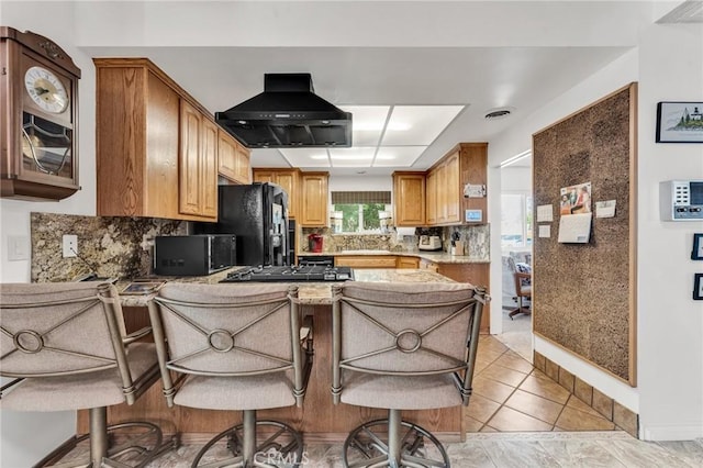 1317 Pacific St, Redlands, CA 92373 - kitchen with extractor fan, tasteful backsplash, a peninsula, black refrigerator with ice dispenser, and glass insert cabinets
