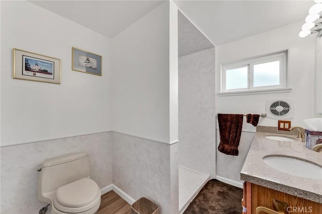 bathroom with vanity, hardwood / wood-style flooring, tile walls, and toilet