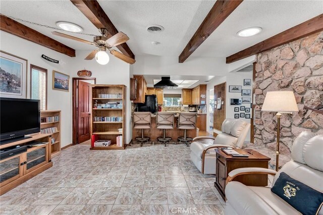 1317 Pacific St, Redlands, CA 92373 - living area with a textured ceiling, a ceiling fan, and beamed ceiling