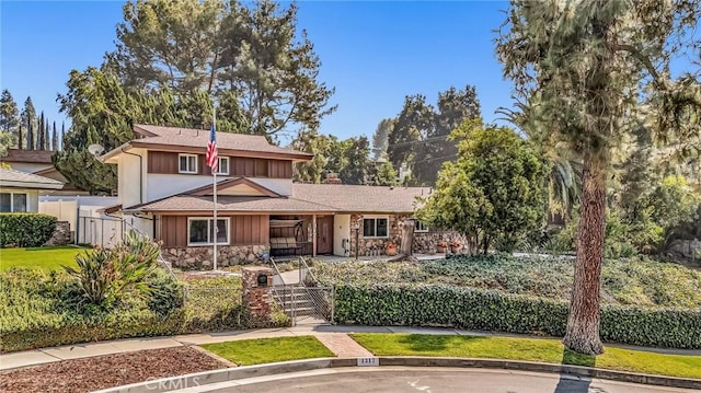 1317 Pacific St, Redlands, CA 92373 - view of front of house with stone siding, a gate, and a fenced front yard