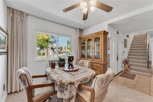 1317 Pacific St, Redlands, CA 92373 - dining room with a textured ceiling, stairway, ceiling fan, baseboards, and light tile patterned flooring