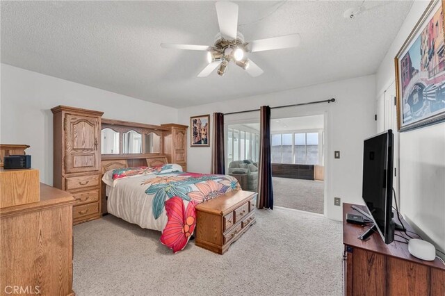 1317 Pacific St, Redlands, CA 92373 - bedroom featuring light colored carpet, a textured ceiling, a ceiling fan, and access to outside