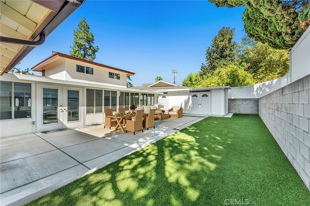 rear view of house featuring french doors, a yard, and a patio